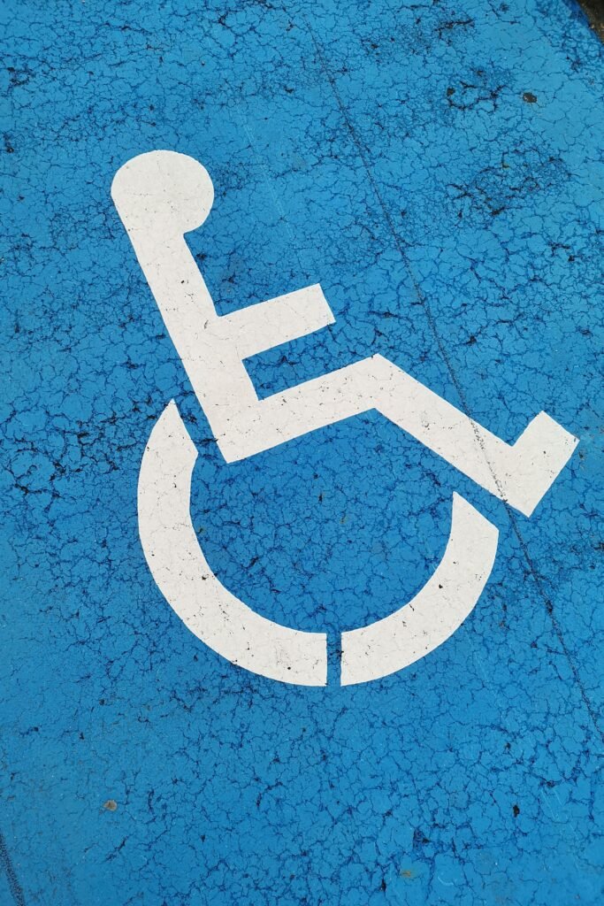 Parking space with wheelchair symbol on blue background for accessibility.