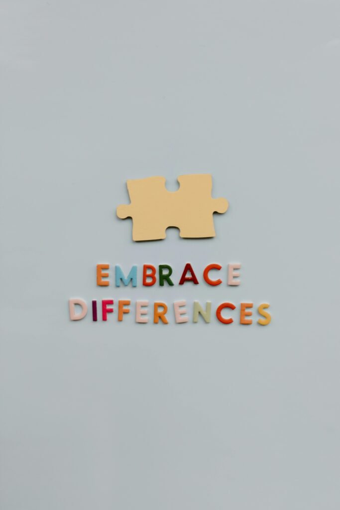 A single puzzle piece and colorful 'Embrace Differences' text on a gray background.