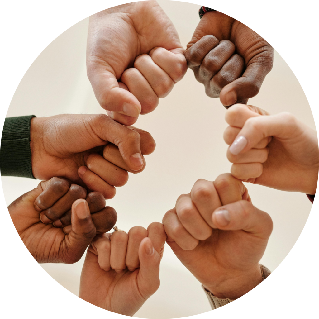 Diverse hands fist bumping