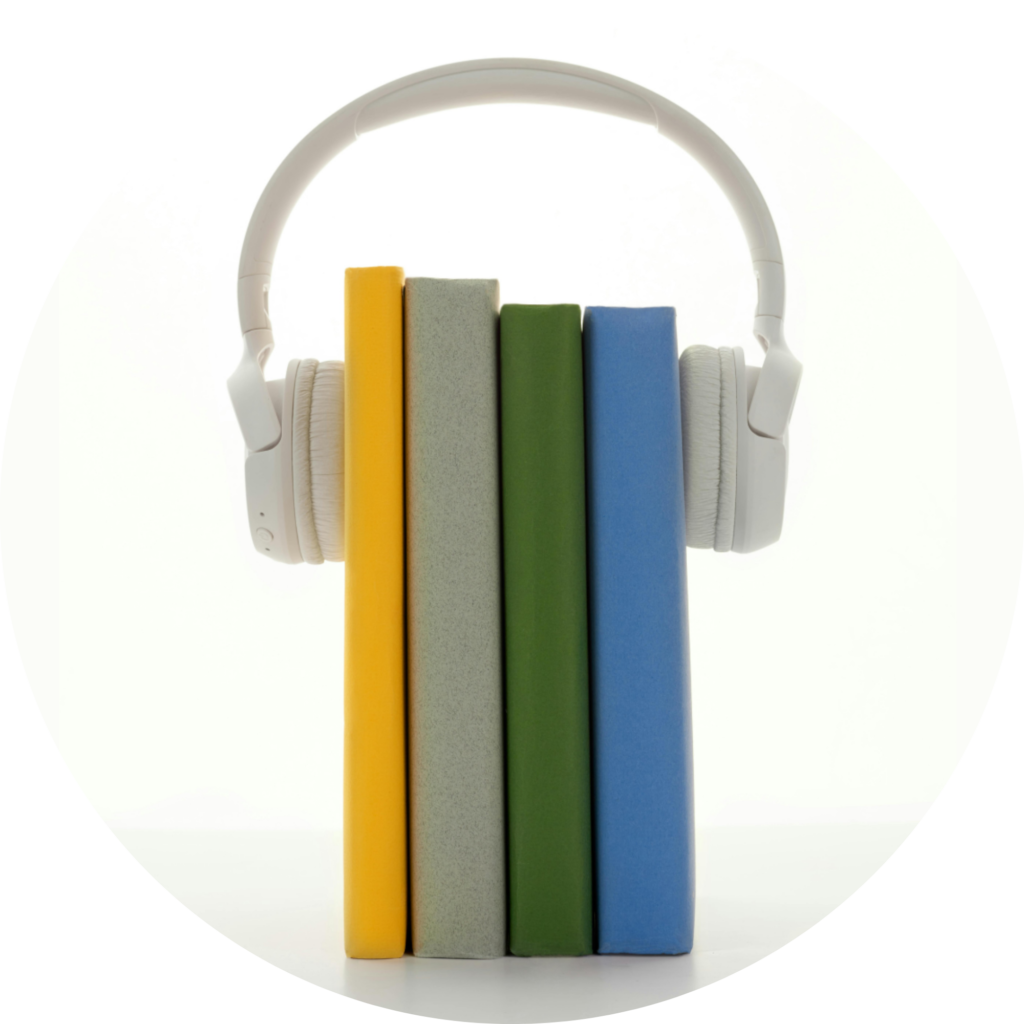 Four books standing upright with headphones on them